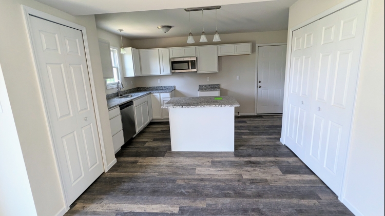 The Auburn II - Kitchen looking at Laundry Closet & island/Pantry